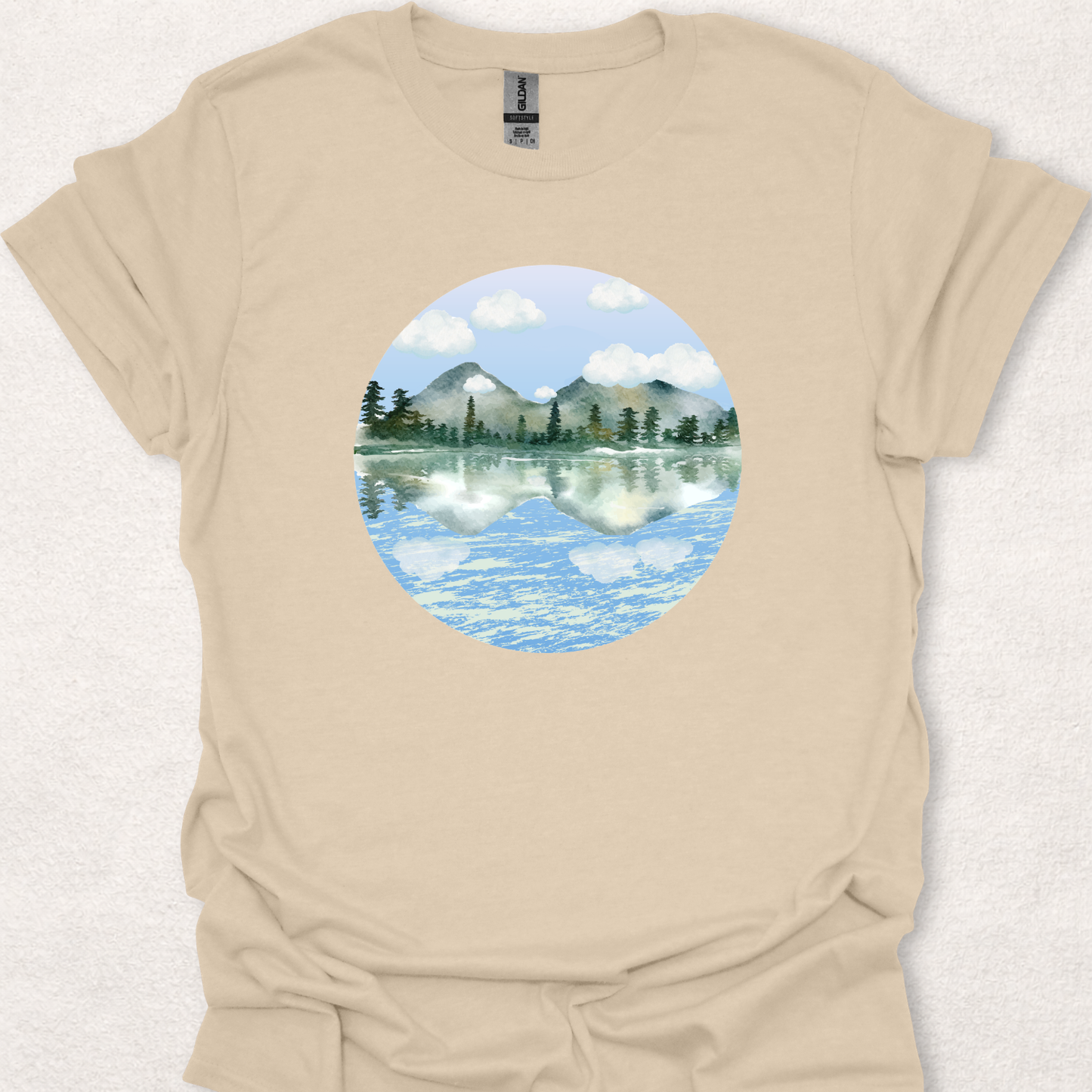 Sand t-shirt featuring the Stillwater watercolor mountain lake reflection design.