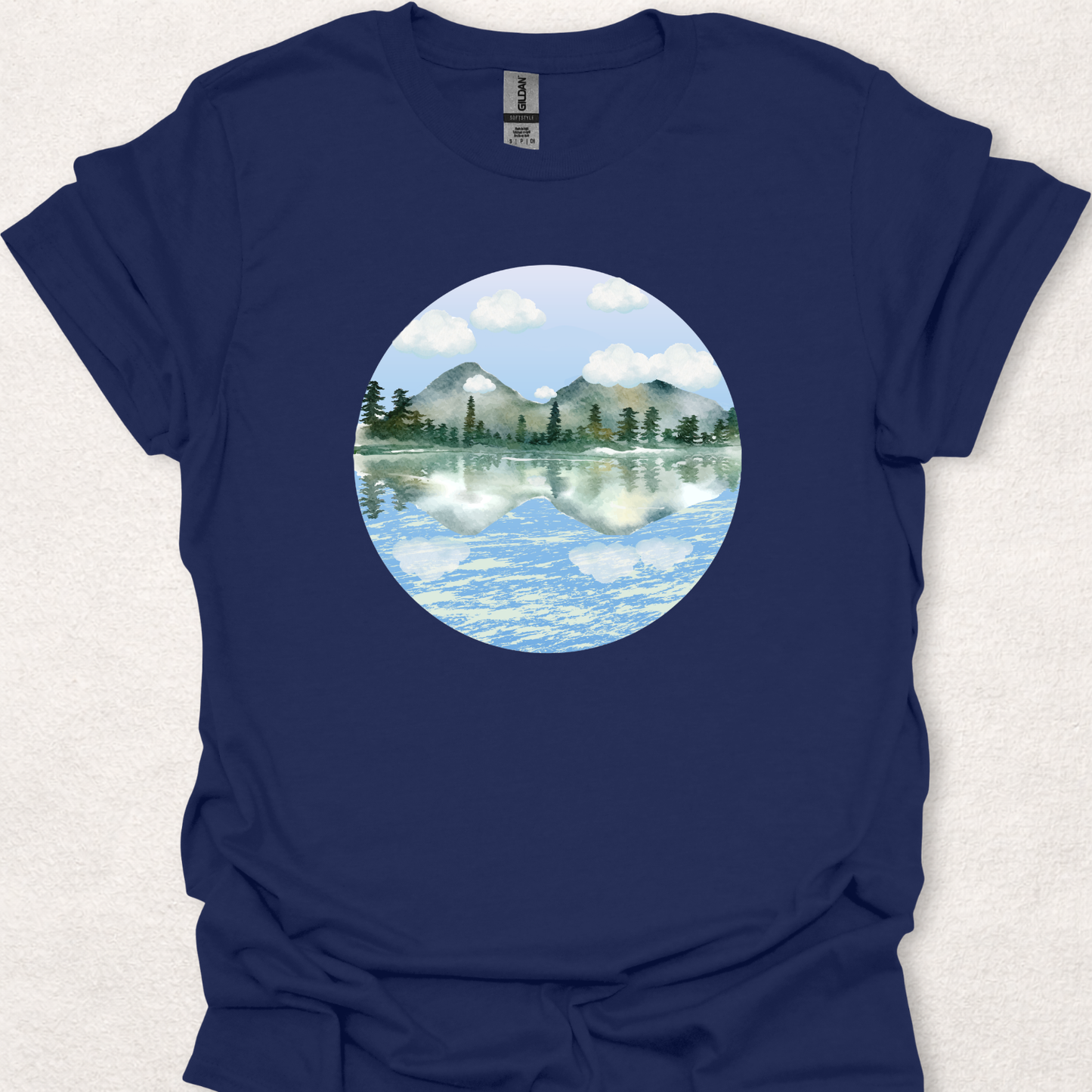 Navy t-shirt featuring the Stillwater watercolor mountain lake reflection design.