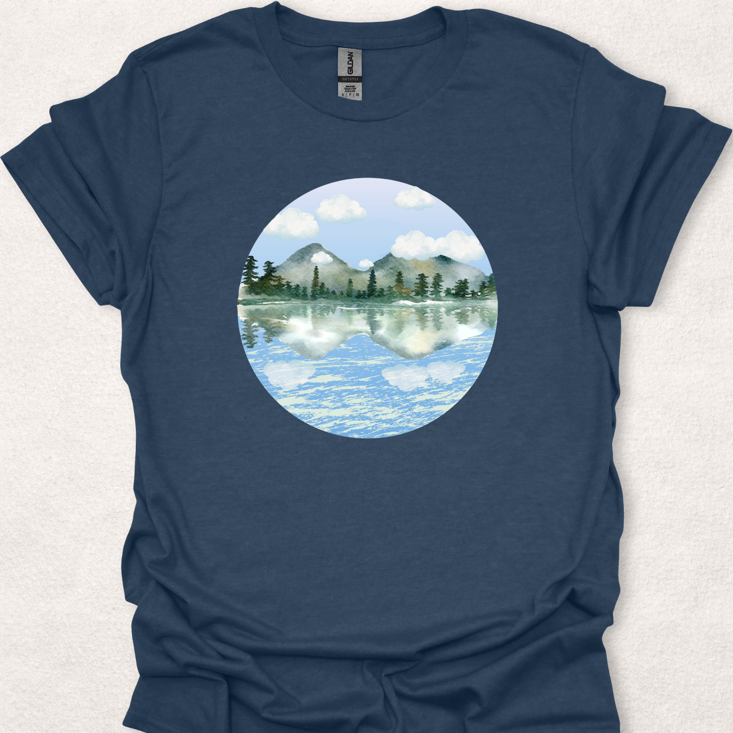 Heather Navy t-shirt featuring the Stillwater watercolor mountain lake reflection design.