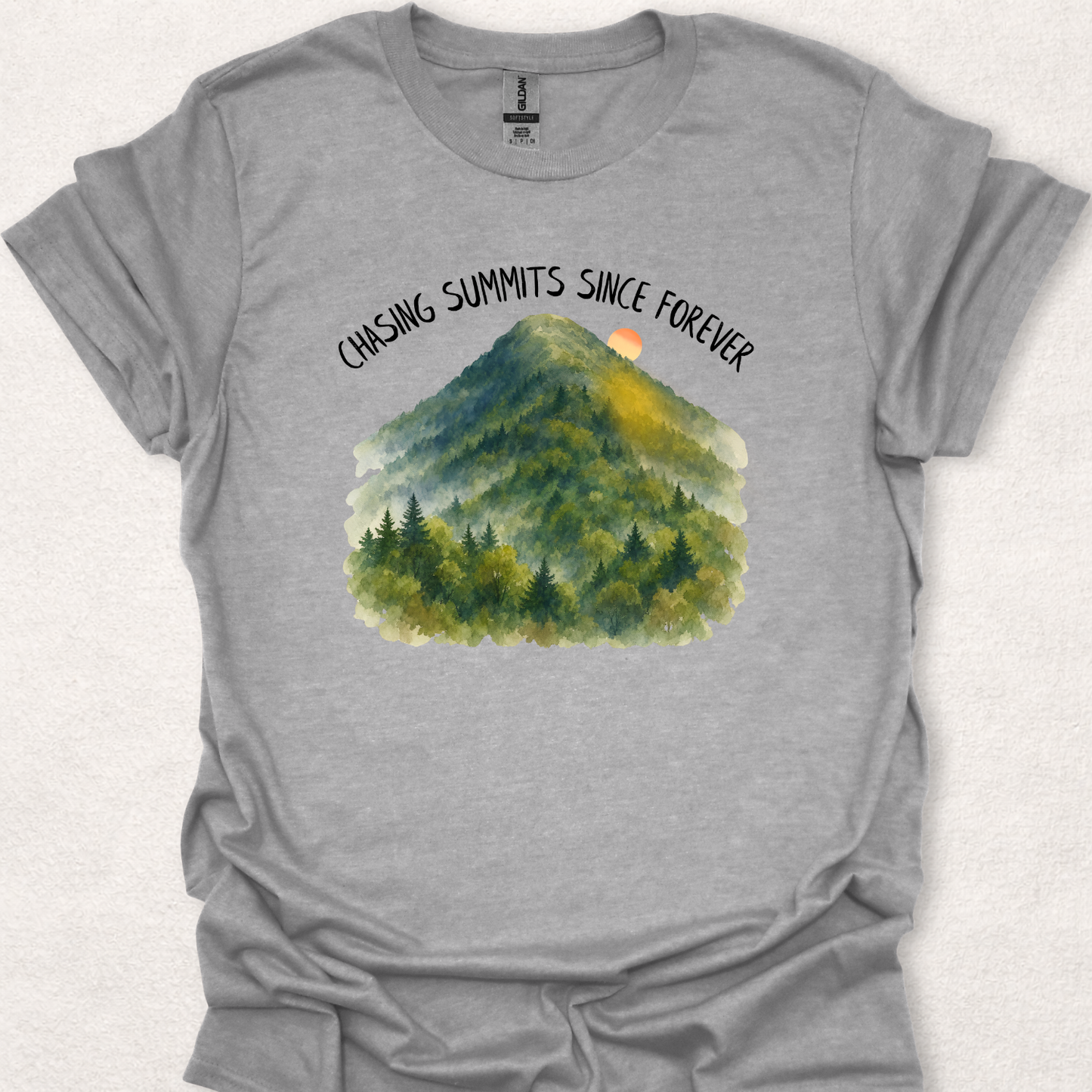 Sport Grey t-shirt featuring the Chasing Summits Since Forever mountain graphic with a watercolor forest landscape and sunrise.